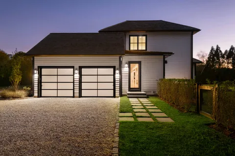 a aerial view of a house with a yard swimming pool and outdoor seating