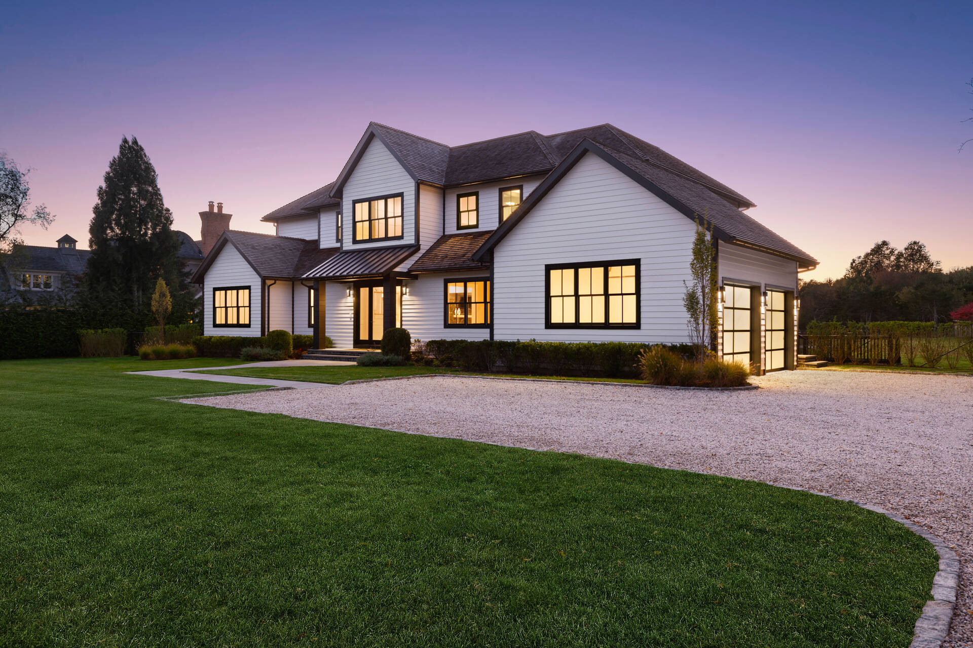 21 Cedar Lane Remsenburg, NY 11960 - Photo 2 of 50 a front view of a house with a yard and garage