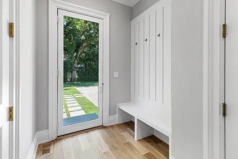 a view of a bedroom with a bed and wooden floor