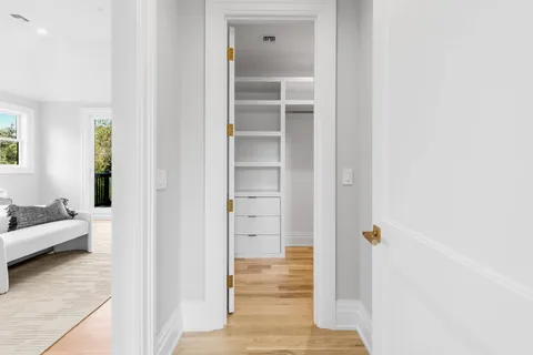 a view of walk in closet with empty racks