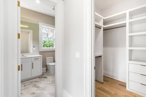 a bedroom with a bed and glass window
