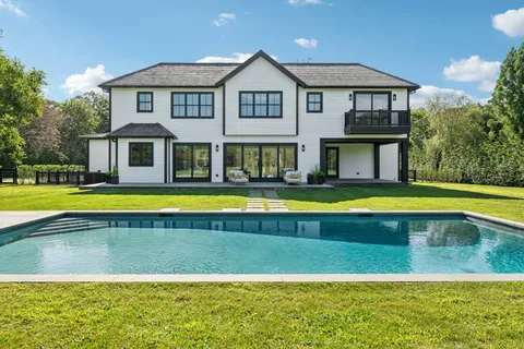 a view of a house with swimming pool and a yard