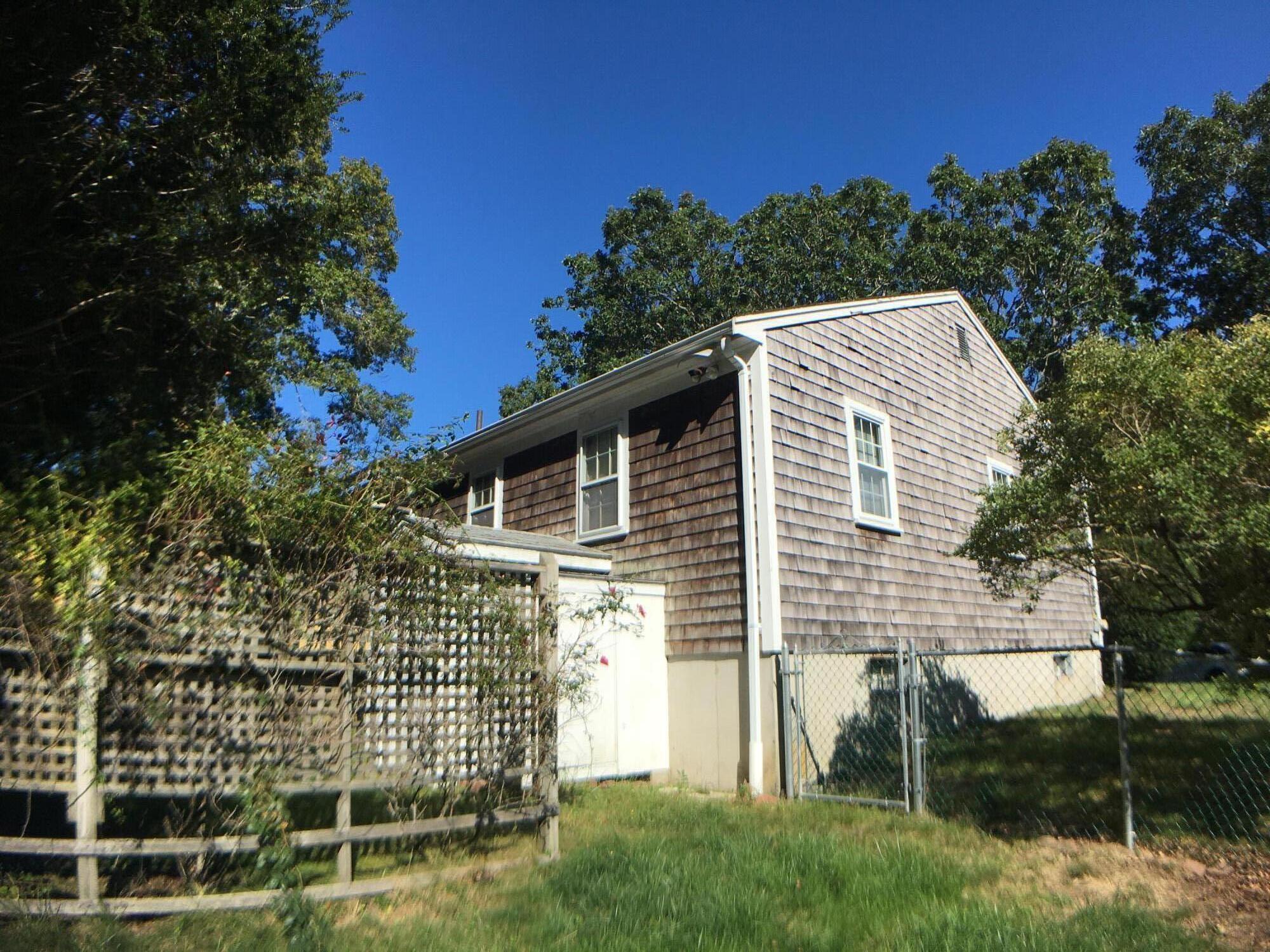 289 Megan Road Hyannis, MA 02601 - Photo 11 of 20 a front view of a house with a garden