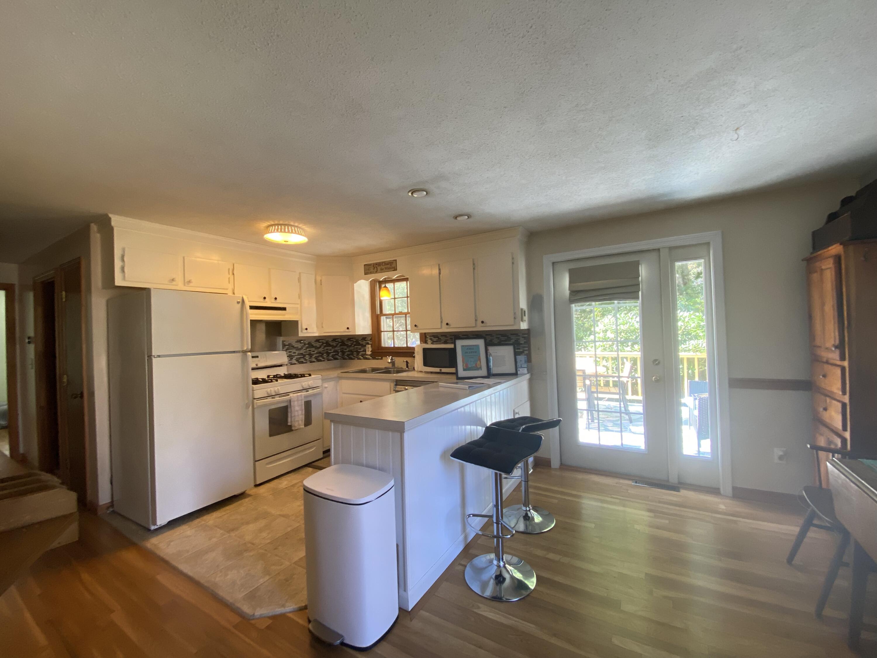 289 Megan Road Hyannis, MA 02601 - Photo 19 of 20 a kitchen with a refrigerator a stove cabinets and wooden floor