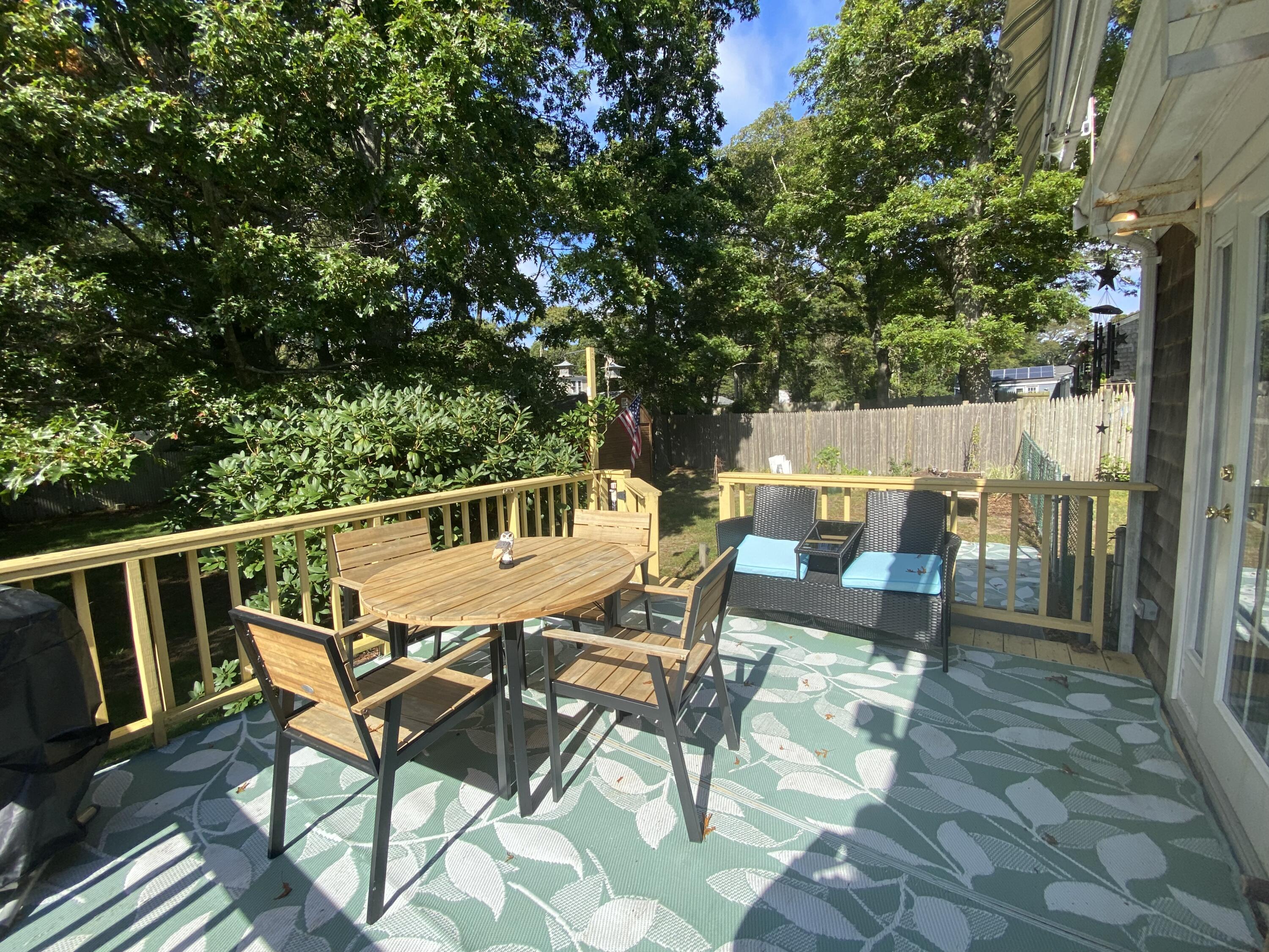 289 Megan Road Hyannis, MA 02601 - Photo 20 of 20 a roof deck with table and chairs and potted plants