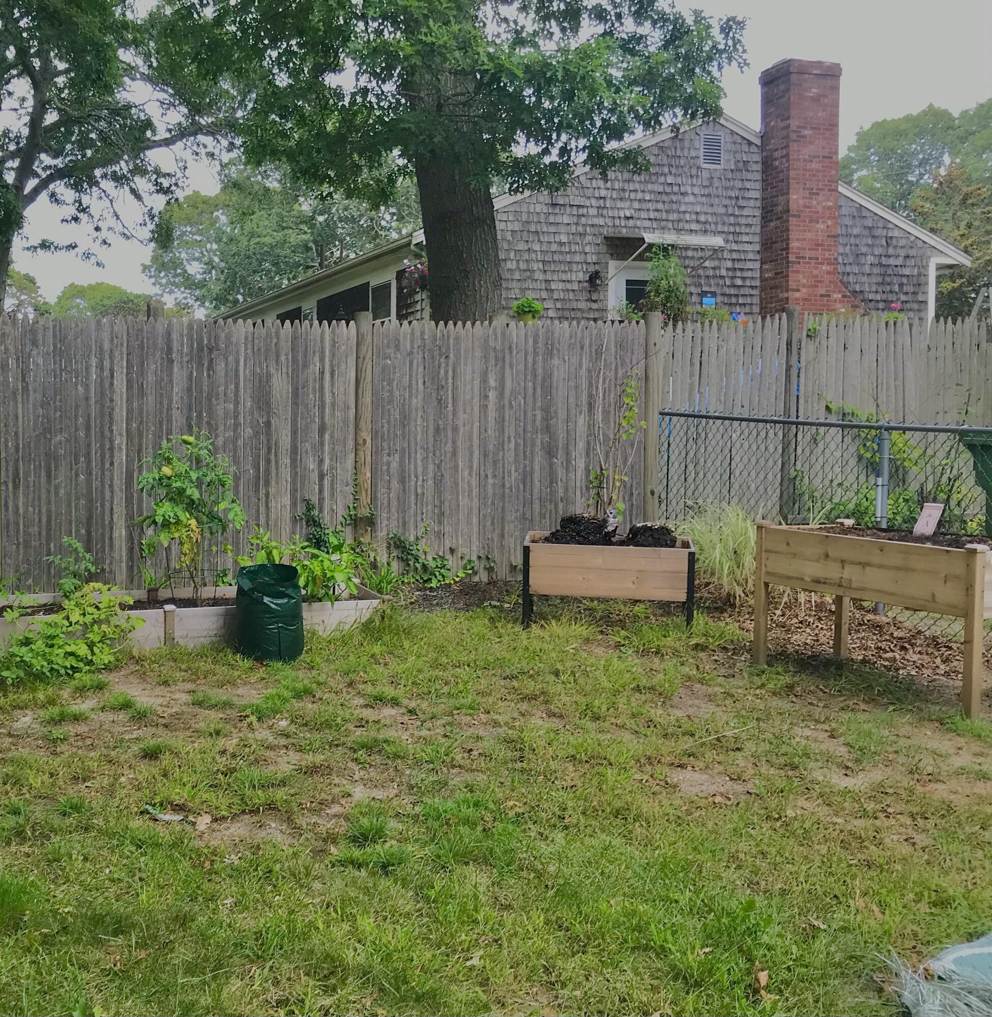 289 Megan Road Hyannis, MA 02601 - Photo 4 of 20 a backyard of a house with yard and outdoor seating
