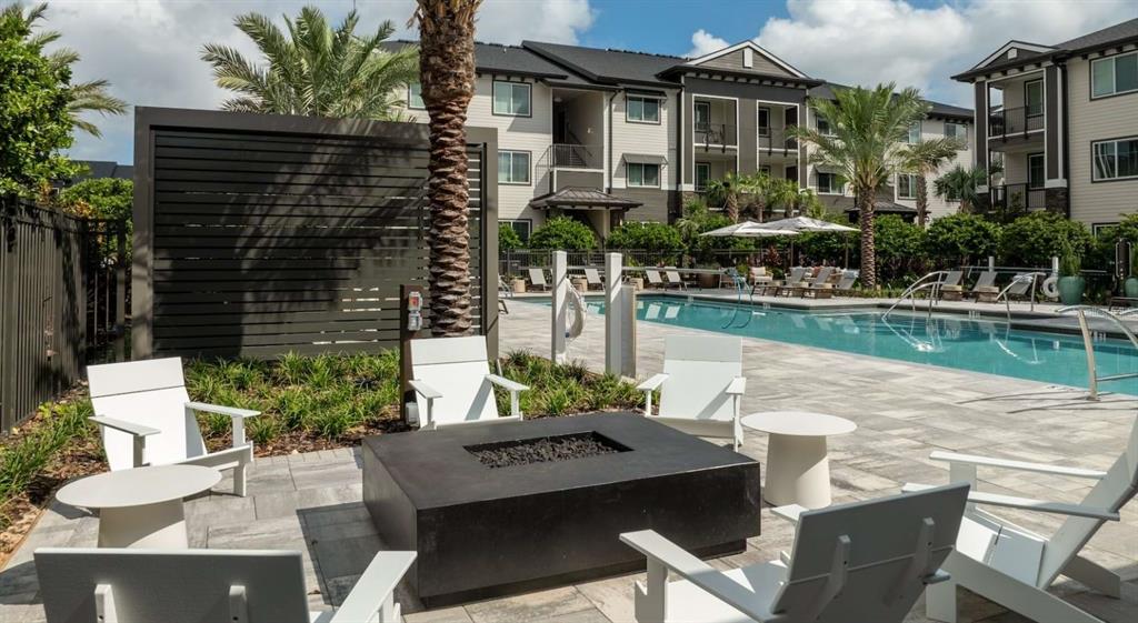 5000 Collina Terrace, Unit TH1 Clermont, FL 34711 - Photo 5 of 28 a view of a patio with table and chairs and potted plants