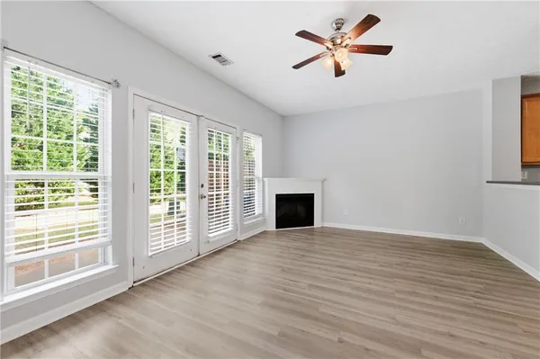 wooden floor in an empty room with a window