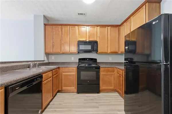 a kitchen with a sink stove and refrigerator