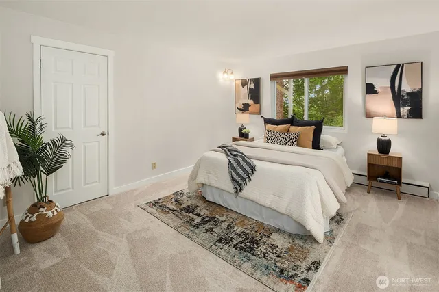 a bedroom with a bed and a potted plant