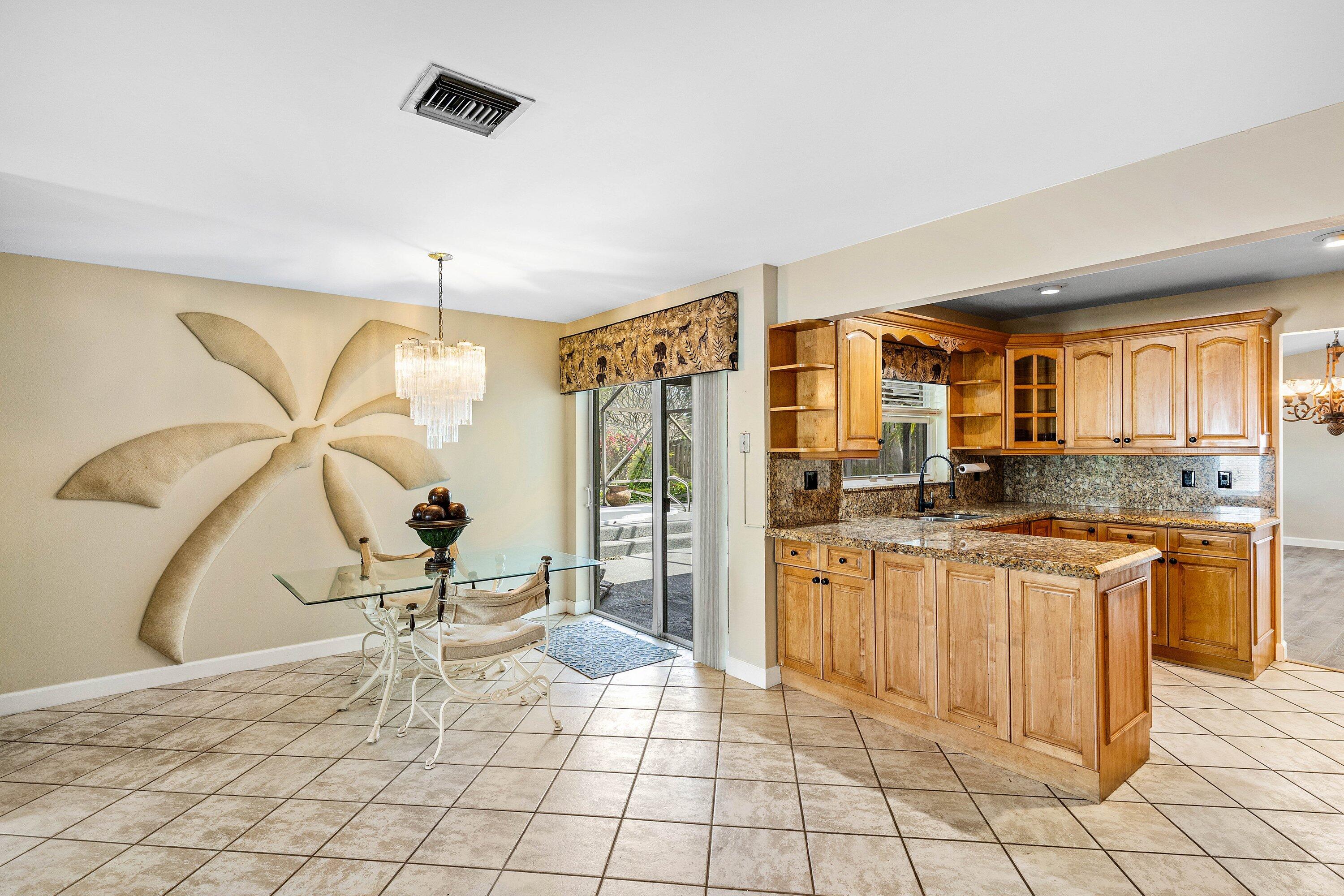 3068 Northwest 25th Way Boca Raton, FL 33434 - Photo 12 of 43 a kitchen with stainless steel appliances granite countertop a stove a sink and a refrigerator