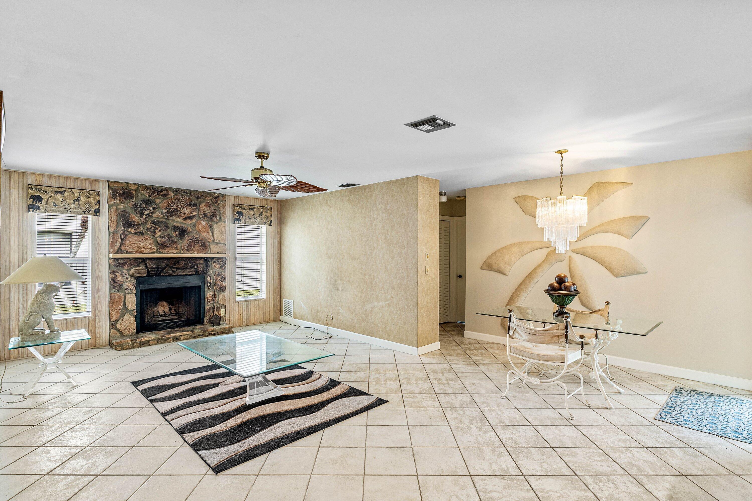 3068 Northwest 25th Way Boca Raton, FL 33434 - Photo 16 of 43 a living room with couch and a fireplace