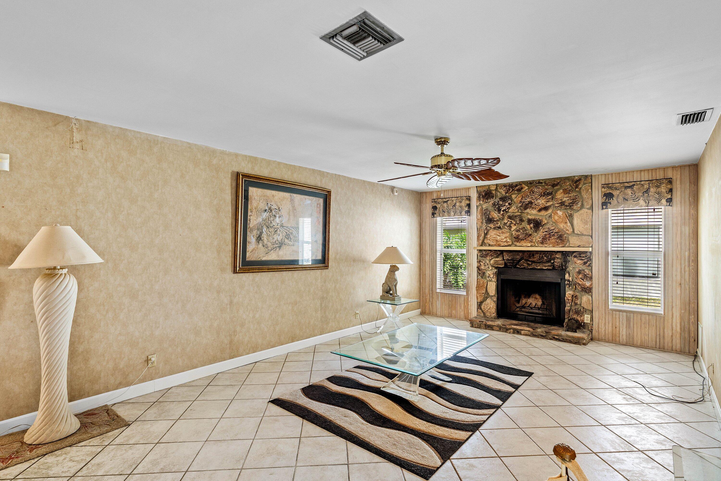 3068 Northwest 25th Way Boca Raton, FL 33434 - Photo 17 of 43 a living room with furniture and a fireplace