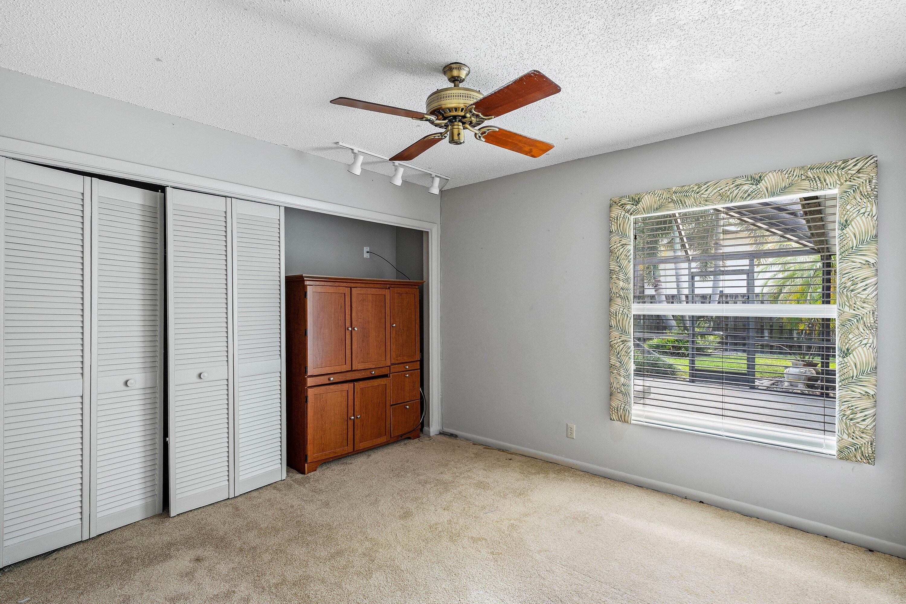 3068 Northwest 25th Way Boca Raton, FL 33434 - Photo 18 of 43 an empty room with closet and windows