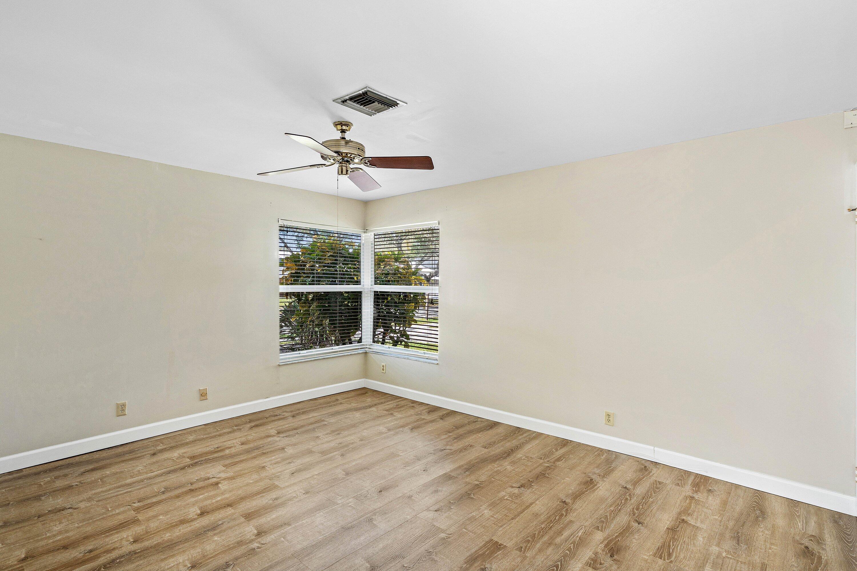 3068 Northwest 25th Way Boca Raton, FL 33434 - Photo 21 of 43 a view of an empty room with wooden floor and a window