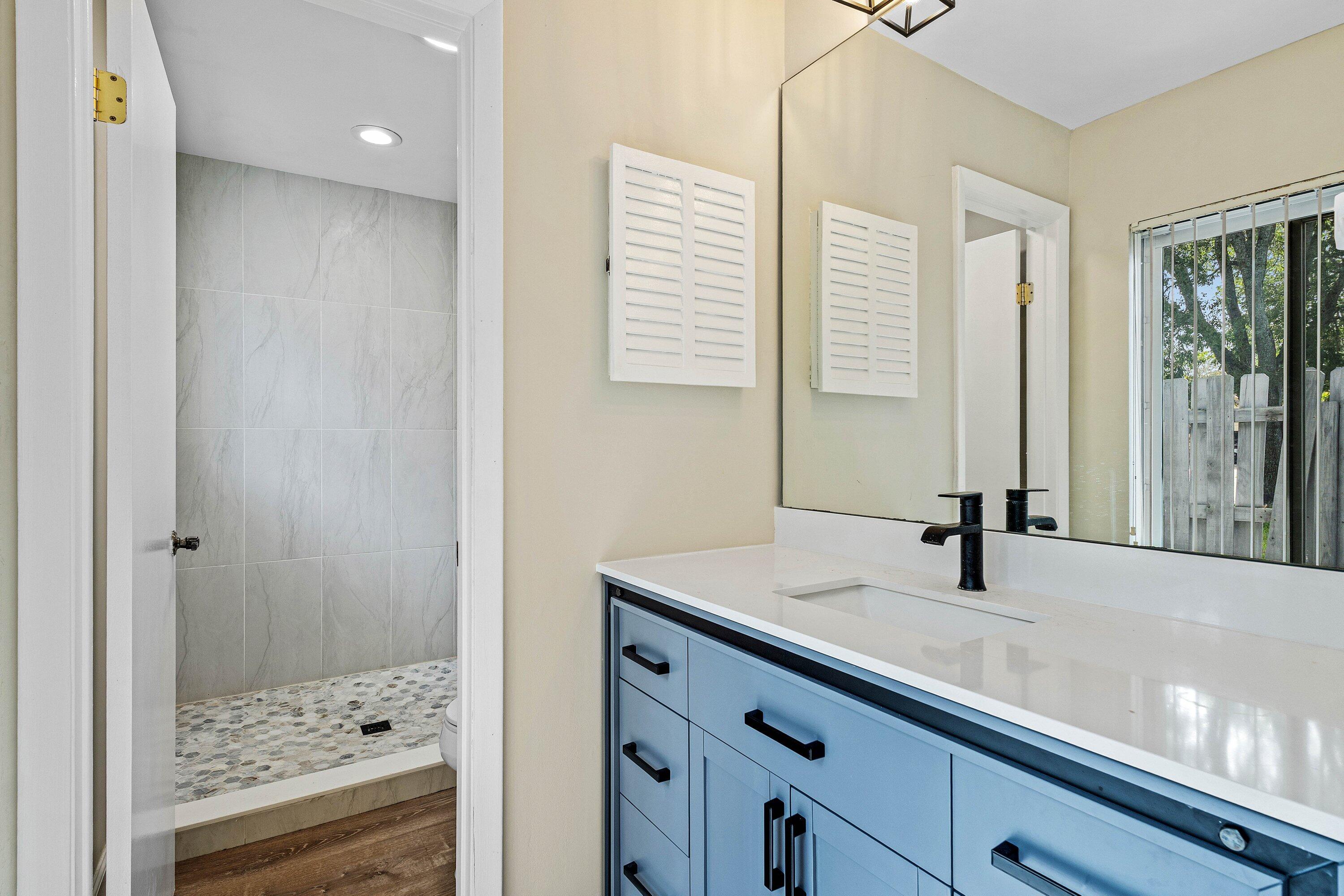 3068 Northwest 25th Way Boca Raton, FL 33434 - Photo 22 of 43 a bathroom with a sink and a mirror
