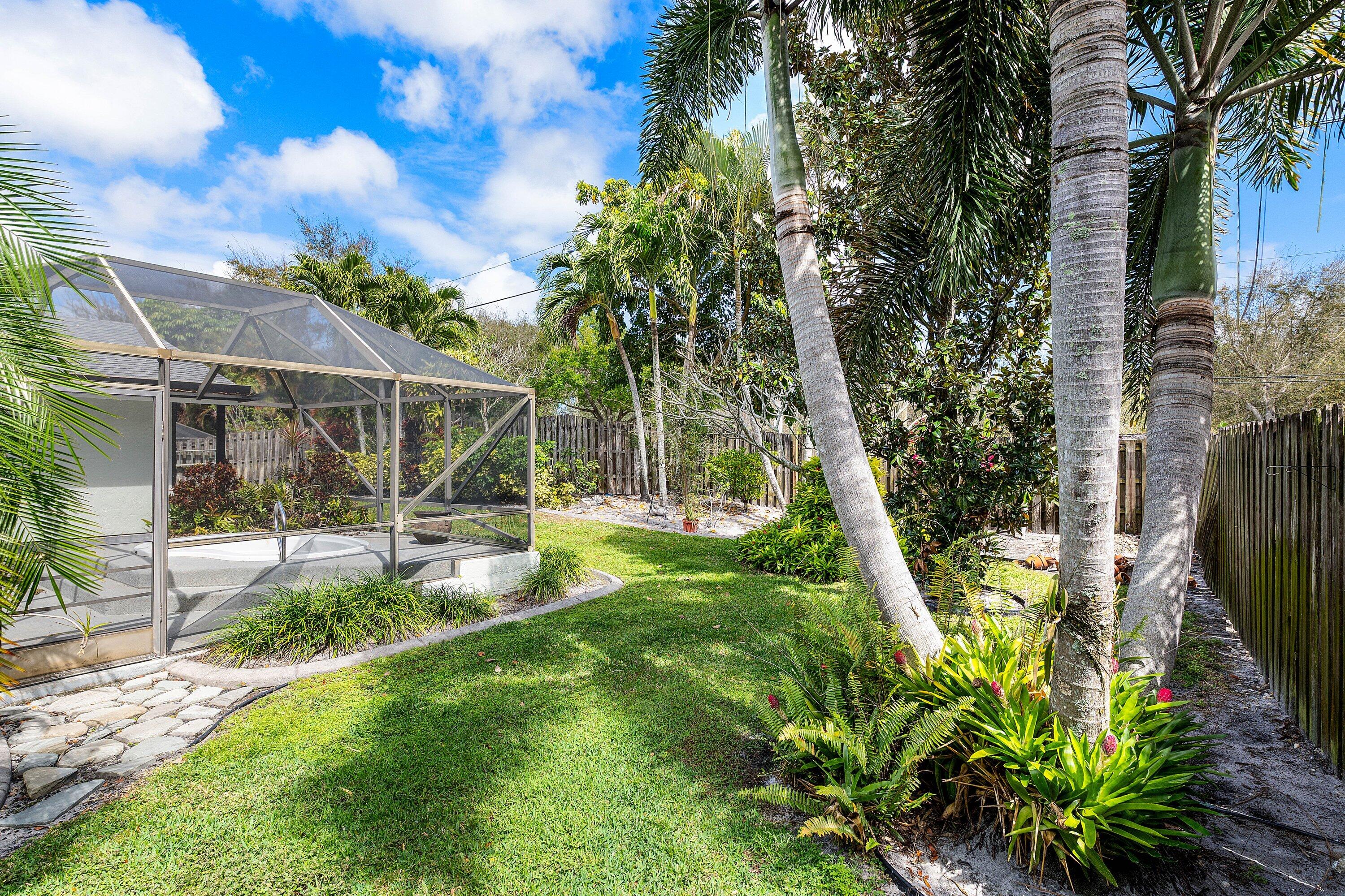3068 Northwest 25th Way Boca Raton, FL 33434 - Photo 24 of 43 a view of a yard with plants and a fountain