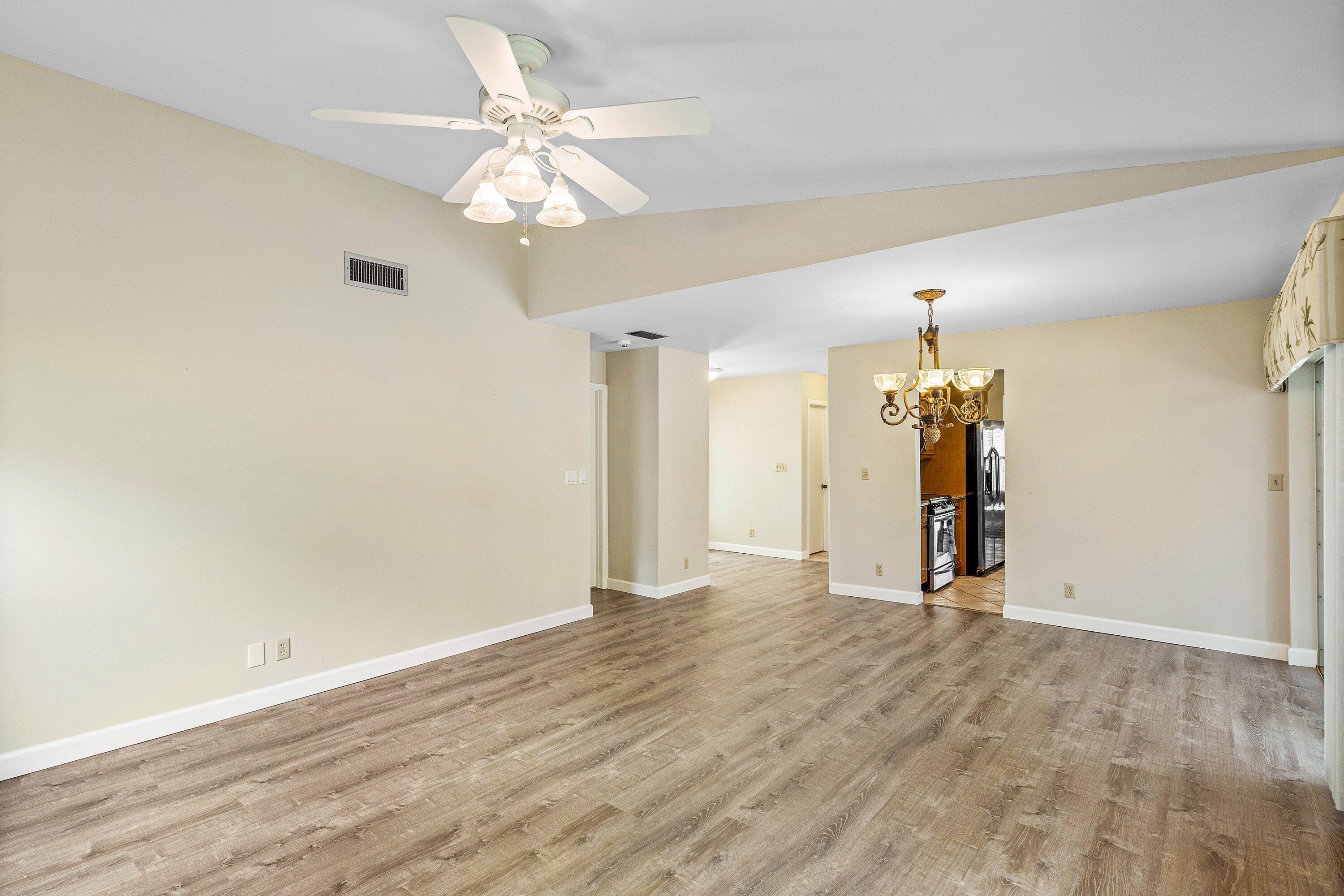 3068 Northwest 25th Way Boca Raton, FL 33434 - Photo 7 of 43 wooden floor in an empty room with a window