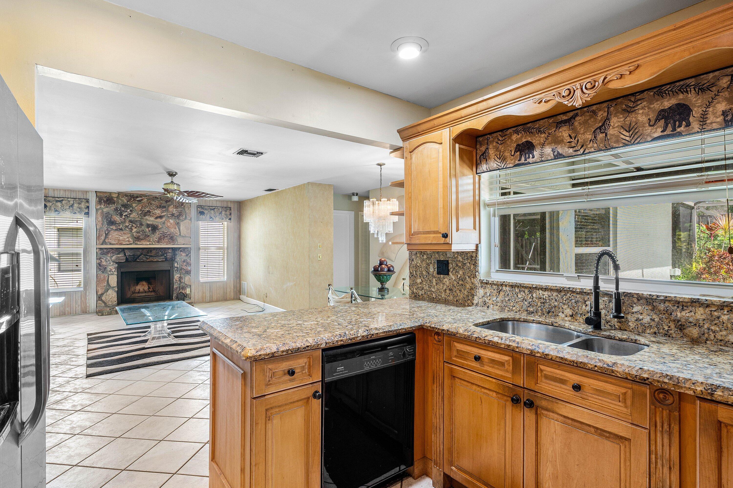 3068 Northwest 25th Way Boca Raton, FL 33434 - Photo 9 of 43 a kitchen with granite countertop a sink and a stove