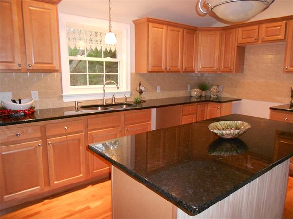 296 Reed Road Westport, MA 02790 - Photo 8 of 14 a kitchen with granite countertop a sink a stove and a wooden cabinets