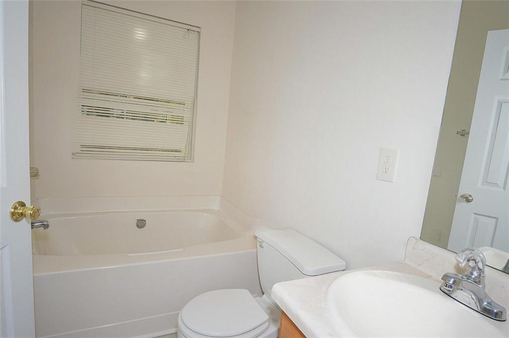 5799 Cedar Croft Lane Lithonia, GA 30058 - Photo 13 of 16 a bathroom with a toilet and a bathtub