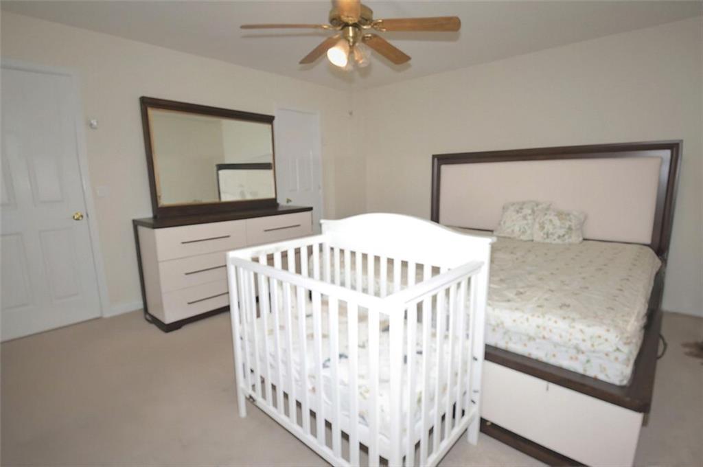 5799 Cedar Croft Lane Lithonia, GA 30058 - Photo 14 of 16 a bedroom with a bed and a window