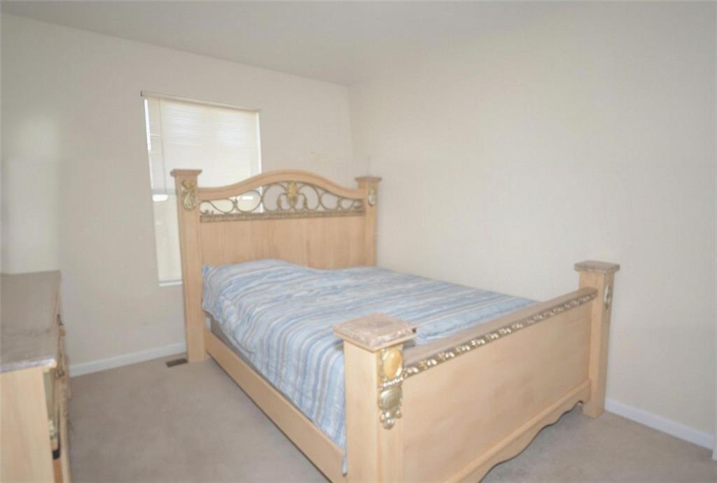 5799 Cedar Croft Lane Lithonia, GA 30058 - Photo 16 of 16 a bedroom with a bed and a dresser