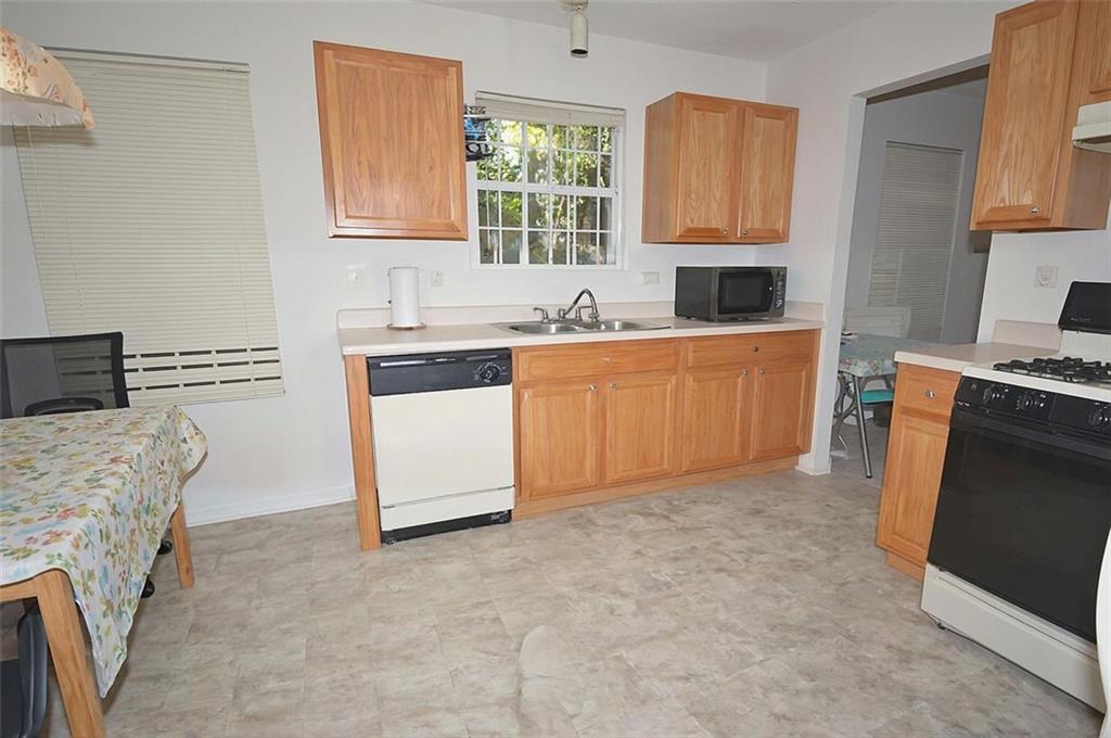 5799 Cedar Croft Lane Lithonia, GA 30058 - Photo 8 of 16 a kitchen with granite countertop a stove top oven sink and cabinets