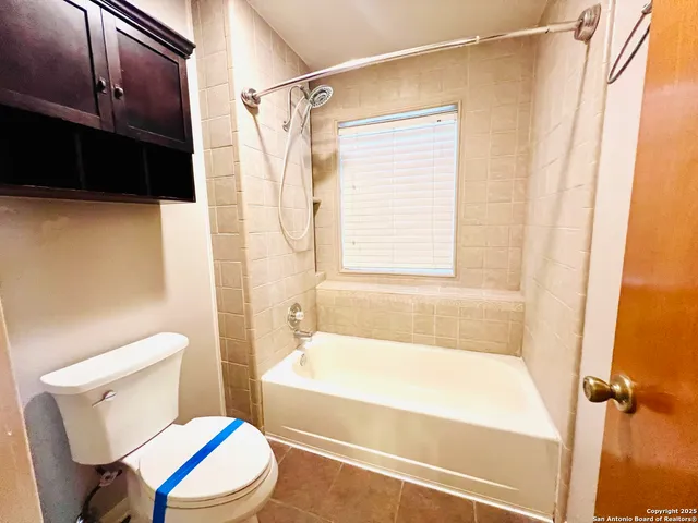 a bathroom with a toilet and a bathtub
