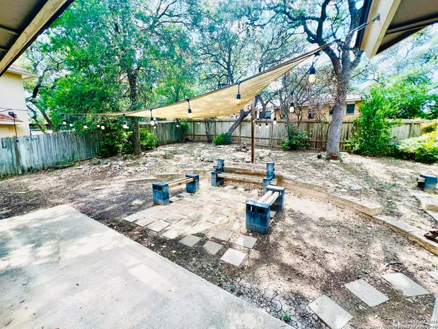 a wooden bench sitting in the middle of a yard