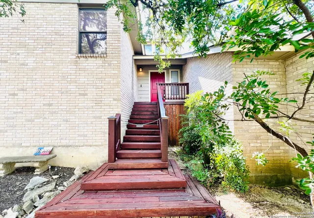 a front view of a house with plants