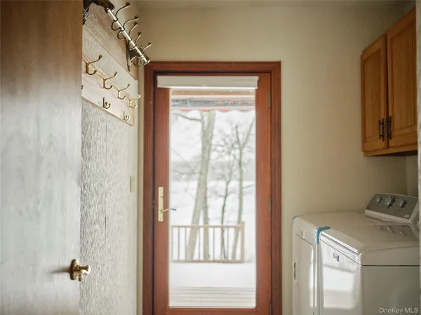 a view of a door and utility room with a window