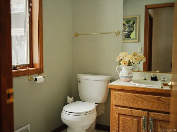 a bathroom with a sink mirror vanity and toilet