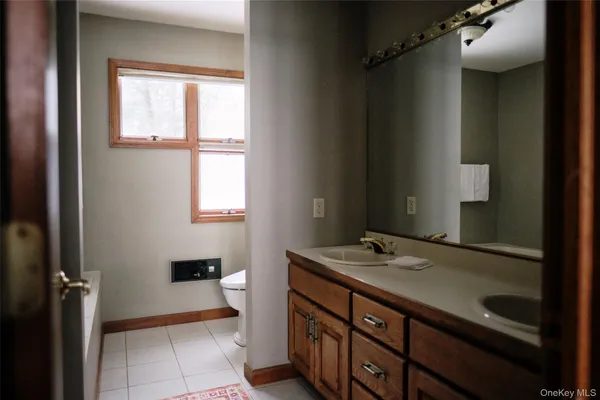 a bathroom with a sink a vanity and a mirror