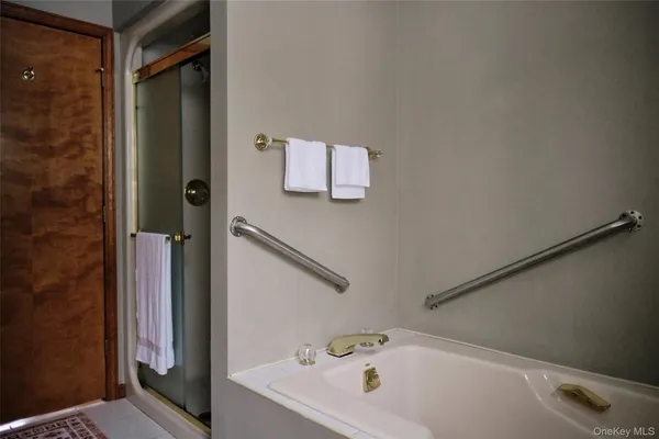 a bathroom with a tub and shower
