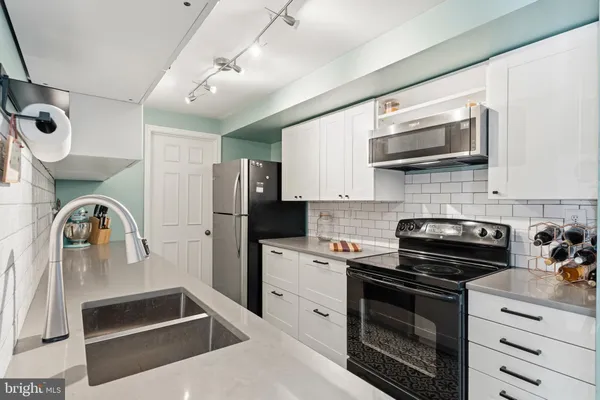 a kitchen with stainless steel appliances granite countertop a stove and a sink