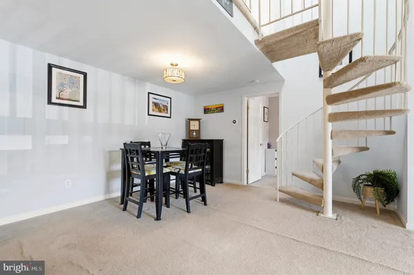 a view of a livingroom with dining room and furniture