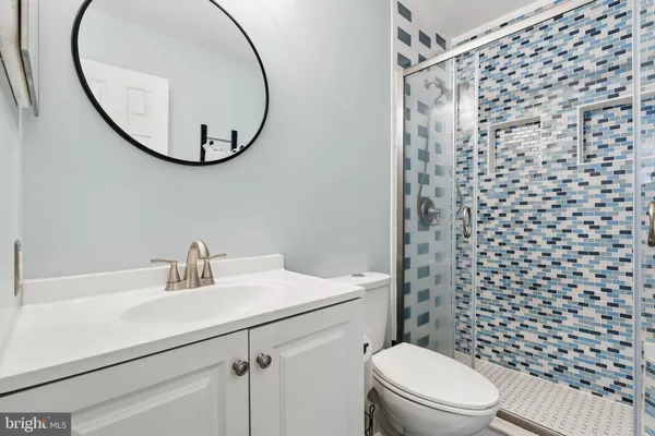 a bathroom with a sink a toilet and a mirror