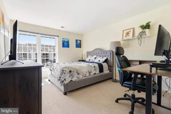 a bedroom with a bed and a desk
