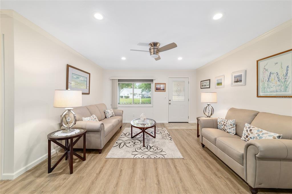 9240 Southwest 90th Court, Unit B Ocala, FL 34481 - Photo 11 of 40 a living room with furniture and a wooden floor