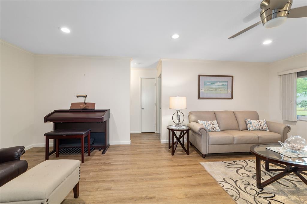 9240 Southwest 90th Court, Unit B Ocala, FL 34481 - Photo 13 of 40 a living room with furniture and a piano