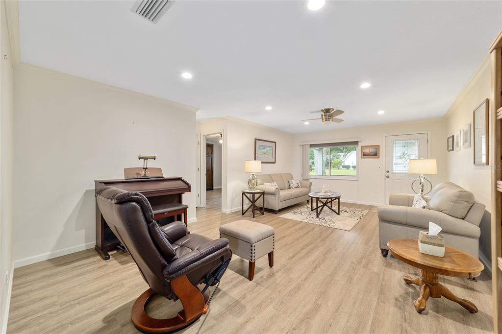 9240 Southwest 90th Court, Unit B Ocala, FL 34481 - Photo 14 of 40 a living room with furniture and a wooden floor