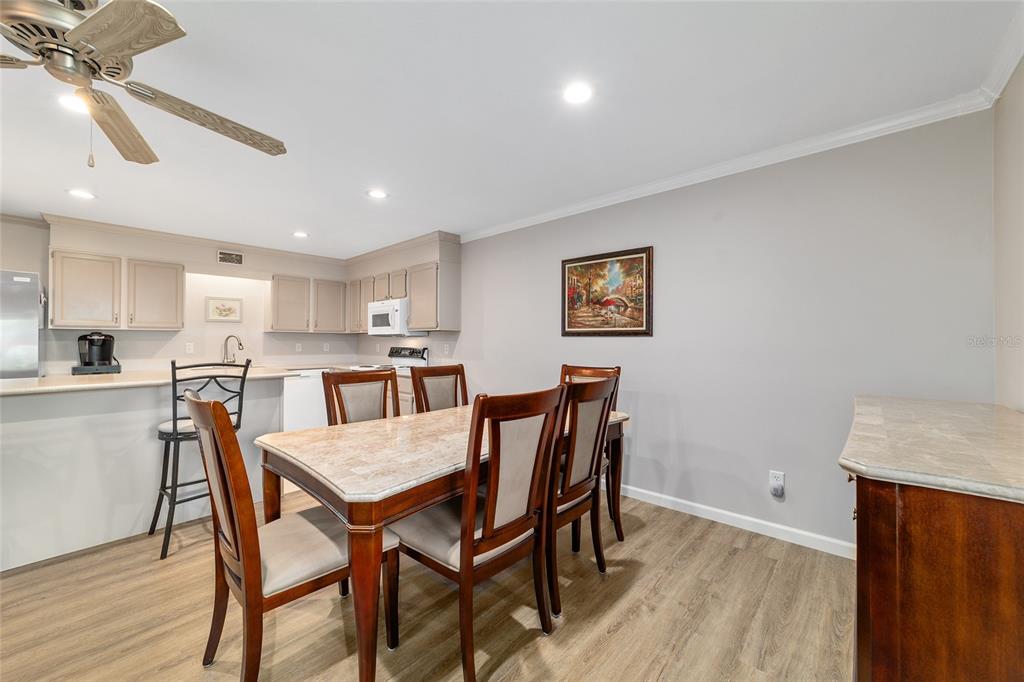 9240 Southwest 90th Court, Unit B Ocala, FL 34481 - Photo 16 of 40 a view of a dining room with furniture and wooden floor