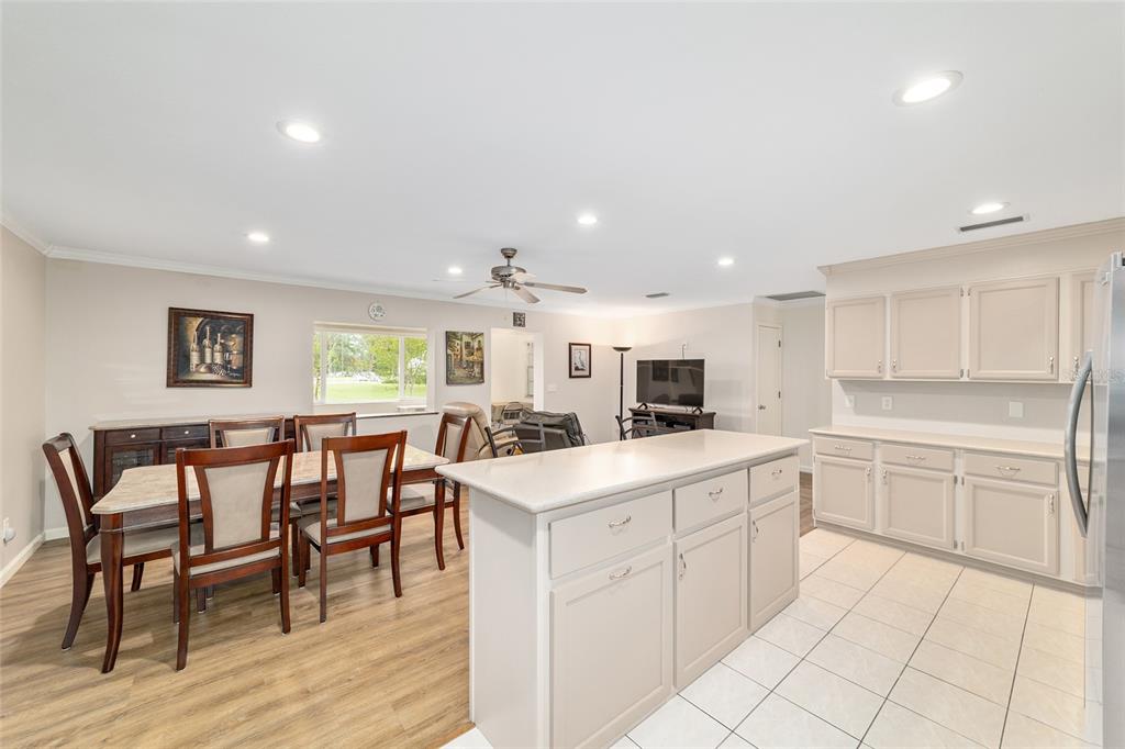 9240 Southwest 90th Court, Unit B Ocala, FL 34481 - Photo 21 of 40 a kitchen with a sink and chairs