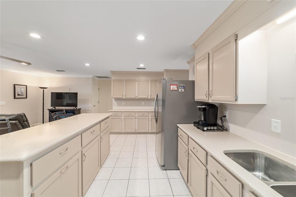 9240 Southwest 90th Court, Unit B Ocala, FL 34481 - Photo 22 of 40 a kitchen with a sink cabinets and appliances