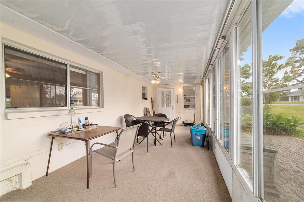 9240 Southwest 90th Court, Unit B Ocala, FL 34481 - Photo 26 of 40 a dining room with furniture and a potted plant