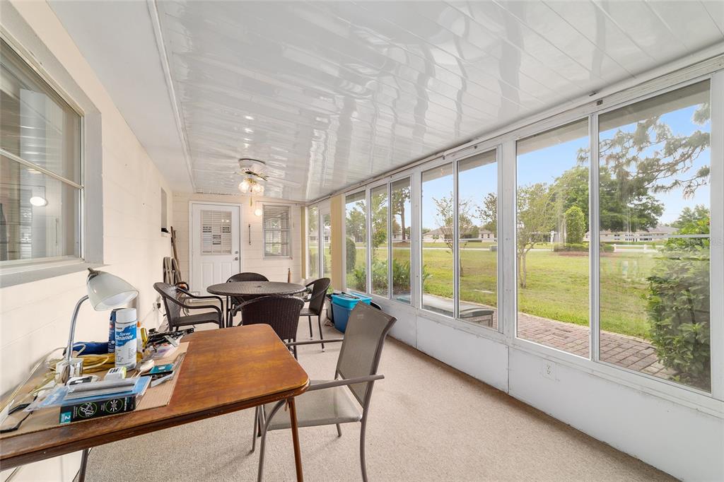 9240 Southwest 90th Court, Unit B Ocala, FL 34481 - Photo 27 of 40 a dining room with furniture water view and a large window
