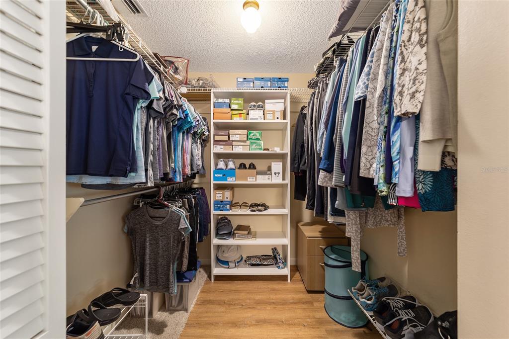 9240 Southwest 90th Court, Unit B Ocala, FL 34481 - Photo 32 of 40 a view of walk in closet with clothes and shoes