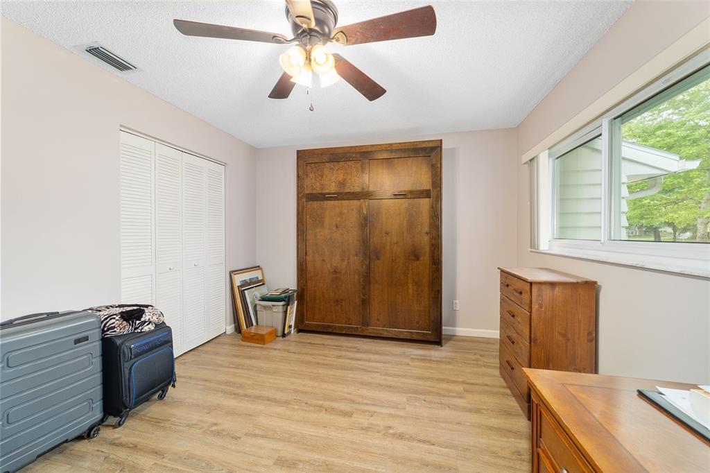 9240 Southwest 90th Court, Unit B Ocala, FL 34481 - Photo 34 of 40 a view of an empty room with a window and wooden floor