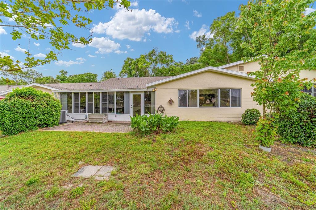 9240 Southwest 90th Court, Unit B Ocala, FL 34481 - Photo 39 of 40 a view of a house with a yard